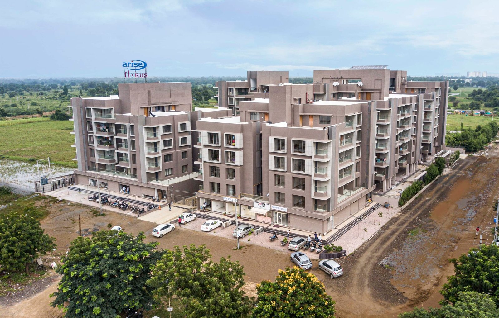 - Arise Florus – Sustainable Luxury Living in Ahmedabad - Arise Florus Eco-Friendly Residential & Commercial Hub - Arise Florus Ahmedabad – Green Design & Modern Comfort - Modern Architecture & Green Living Arise Florus - Arise Florus – Eco-Conscious Architecture in Ahmedabad - Sustainable Residences & Commercial Spaces Arise Florus - Modern Luxury Meets Green Living at Arise Florus - Front view of Arise Florus with landscaped green lawns - Child playing in playground at Arise Florus community garden - Senior citizens enjoying seating area amidst Arise Florus greenery - Panoramic street-facing fenestration at Arise Florus apartments - Solar panels and rainwater harvesting setup at Arise Florus