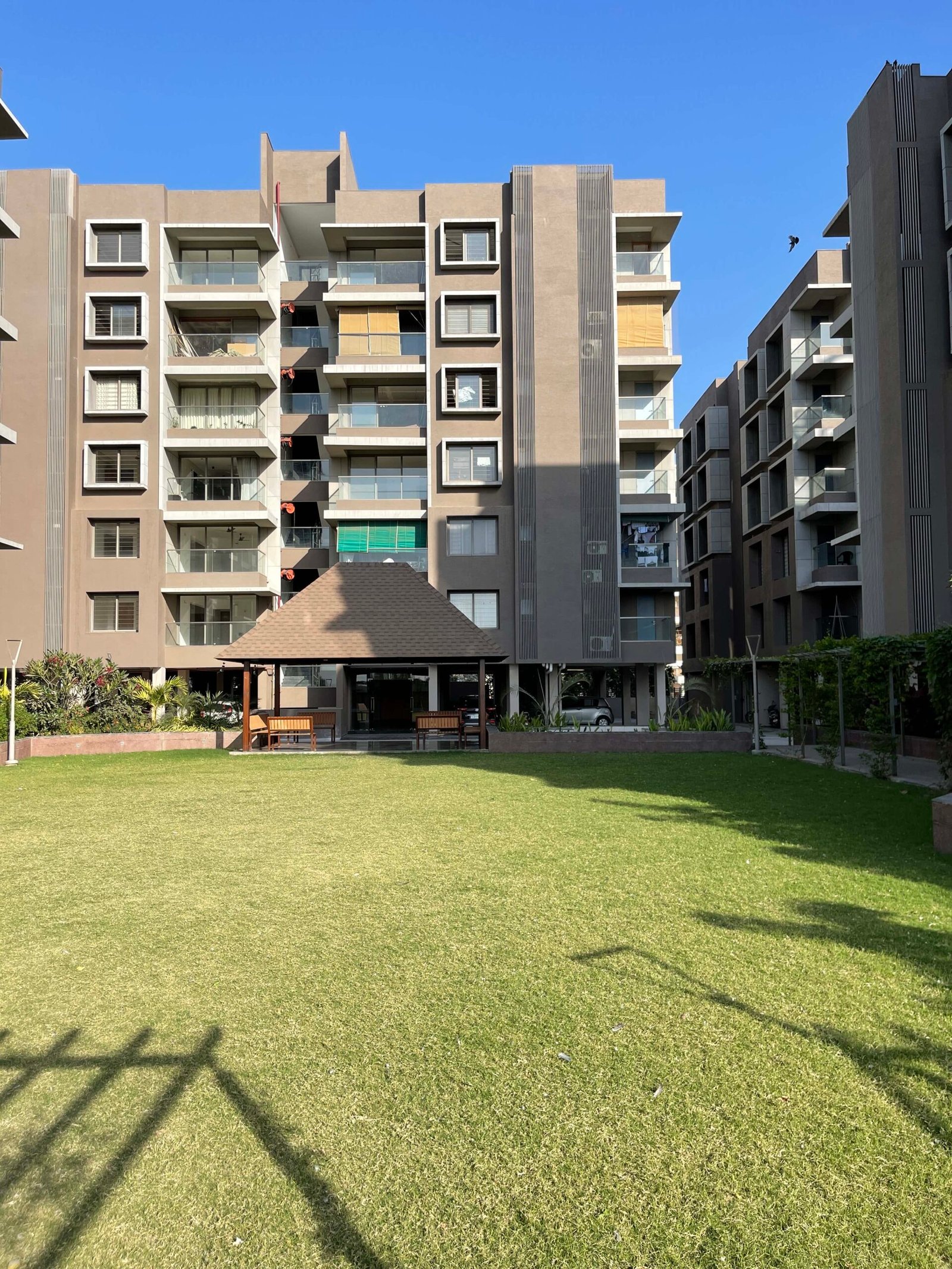 - Arise Florus – Sustainable Luxury Living in Ahmedabad - Arise Florus Eco-Friendly Residential & Commercial Hub - Arise Florus Ahmedabad – Green Design & Modern Comfort - Modern Architecture & Green Living Arise Florus - Arise Florus – Eco-Conscious Architecture in Ahmedabad - Sustainable Residences & Commercial Spaces Arise Florus - Modern Luxury Meets Green Living at Arise Florus - Front view of Arise Florus with landscaped green lawns - Child playing in playground at Arise Florus community garden - Senior citizens enjoying seating area amidst Arise Florus greenery - Panoramic street-facing fenestration at Arise Florus apartments - Solar panels and rainwater harvesting setup at Arise Florus