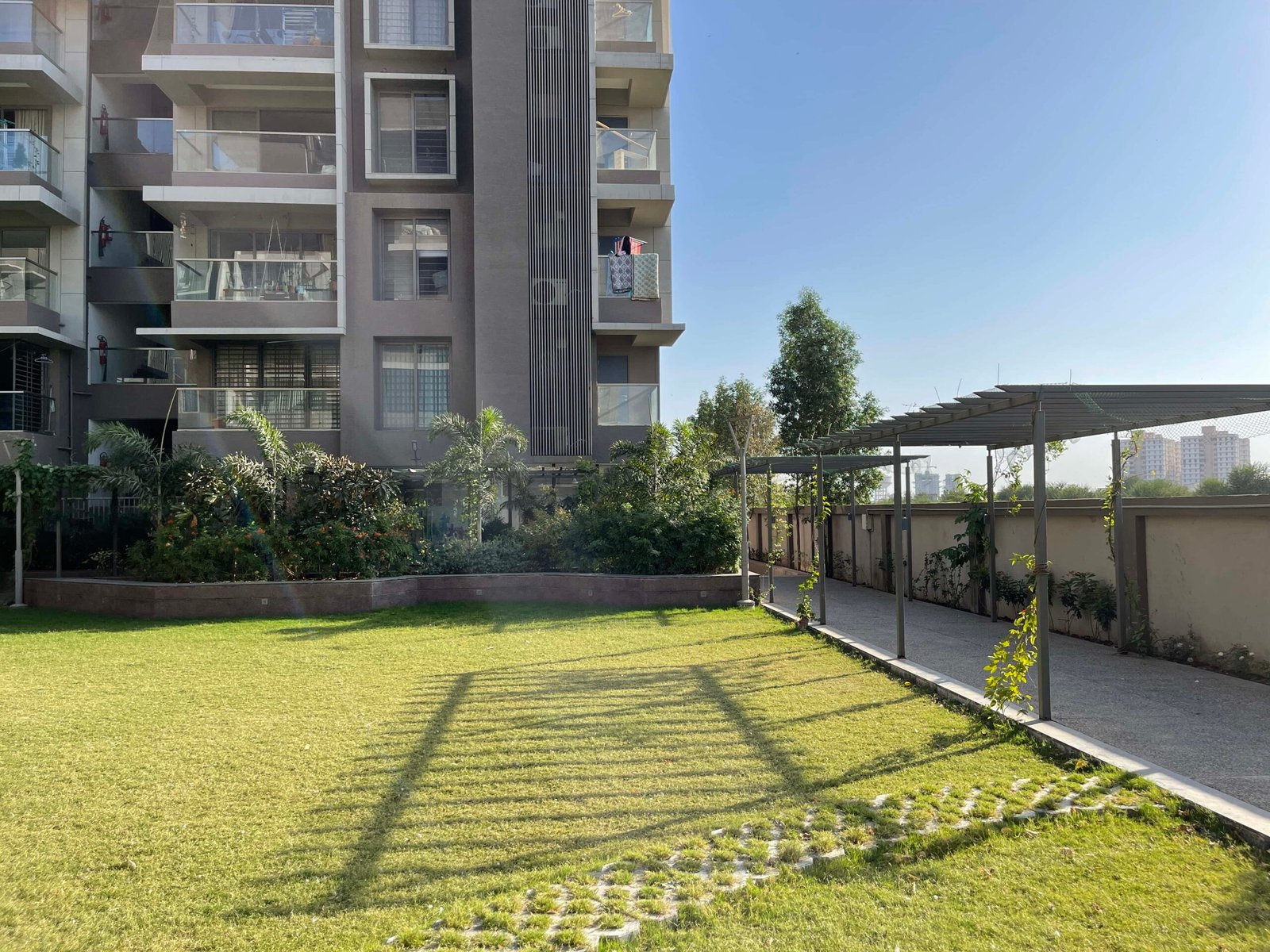 - Arise Florus – Sustainable Luxury Living in Ahmedabad - Arise Florus Eco-Friendly Residential & Commercial Hub - Arise Florus Ahmedabad – Green Design & Modern Comfort - Modern Architecture & Green Living Arise Florus - Arise Florus – Eco-Conscious Architecture in Ahmedabad - Sustainable Residences & Commercial Spaces Arise Florus - Modern Luxury Meets Green Living at Arise Florus - Front view of Arise Florus with landscaped green lawns - Child playing in playground at Arise Florus community garden - Senior citizens enjoying seating area amidst Arise Florus greenery - Panoramic street-facing fenestration at Arise Florus apartments - Solar panels and rainwater harvesting setup at Arise Florus