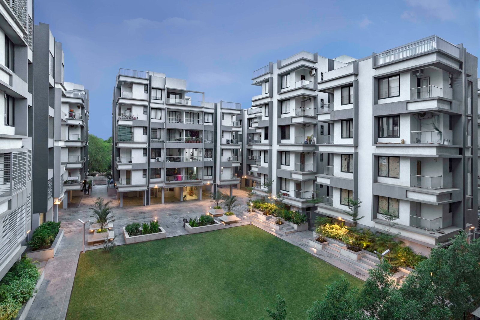 - Exterior view of Arise Western residential towers along S. G. Highway with landscaped frontage - Aerial perspective showing the clubhouse and green spaces between Arise Western buildings - Modern gymnasium interior at Arise Western featuring fitness equipment and natural light - Children and elderly enjoying the landscaped courtyard and walking paths at Arise Western - Furnished 3 BHK apartment living room with contemporary finishes and open layout