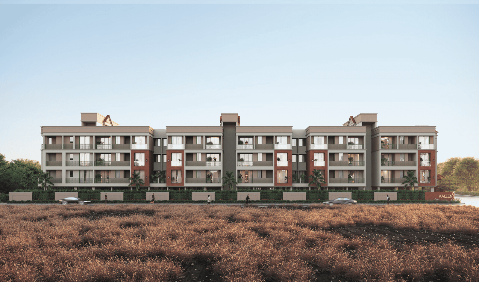 - Front elevation of Kaizen 57 showcasing exposed brick façade, sloped terracotta roofs, and ornate balcony railings - Aerial view of Kaizen 57 residential blocks surrounded by landscaped greens and community spaces - Grand entrance gateway of Kaizen 57 with brick pillars and integrated signage - Children’s play area and shaded seating zone within Kaizen 57’s landscaped courtyard - Balcony detail at Kaizen 57 featuring decorative metal railings and arched windows