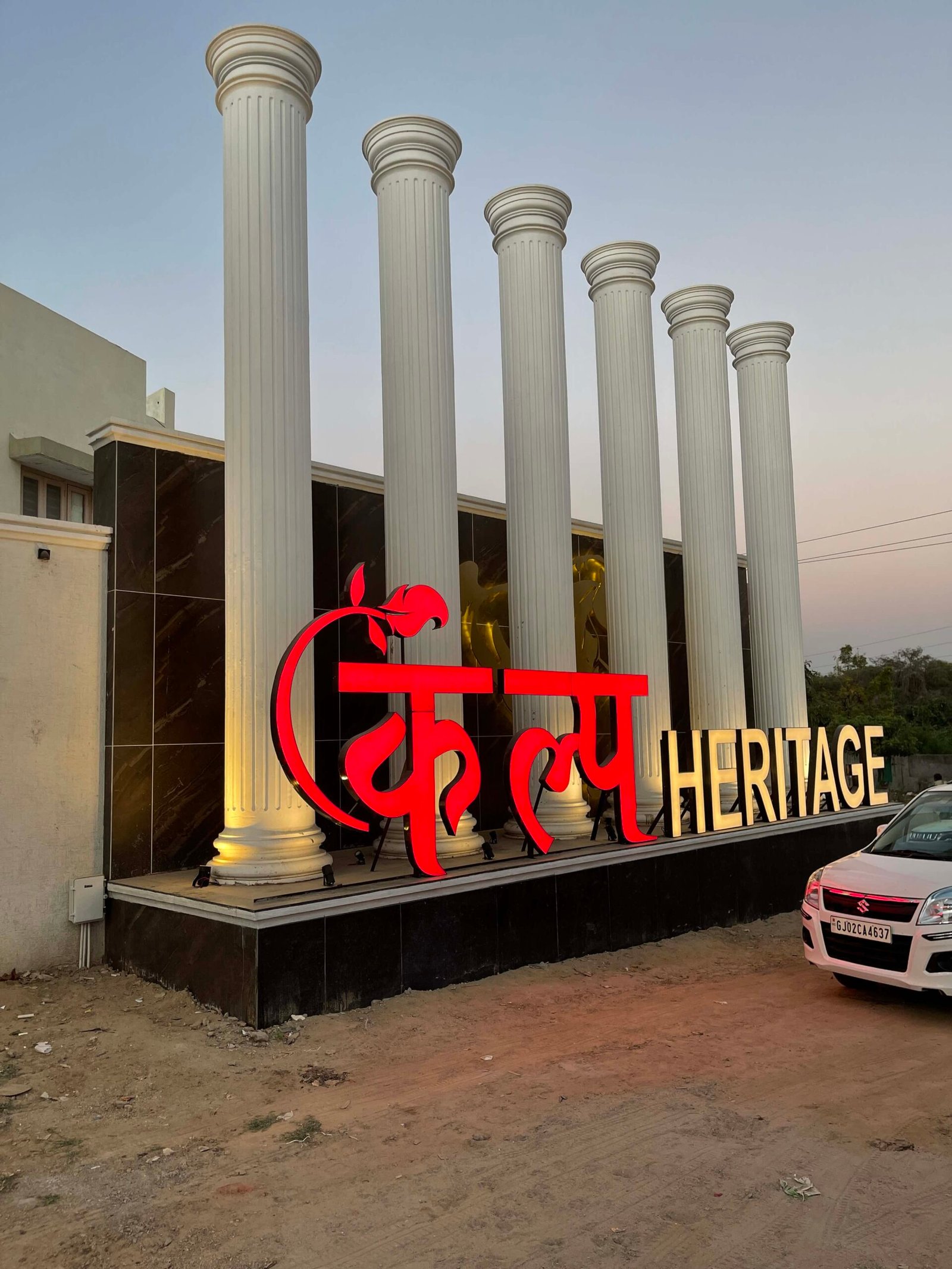 - Kalp Heritage – Colonial Style 3 BHK Bungalows in Mehsana - Kalp Heritage by Shree Hari Buildcon Mehsana Residential Project - Traditional Indian Bungalows with Landscape Design Kalp Heritage - 3 BHK Heritage Bungalows in Mehsana Kalp Groups - Kalp Heritage – Colonial Style Bungalows in Mehsana - 3 BHK Residential Scheme by Shree Hari Buildcon - Kalp Heritage – Traditional Architecture Meets Modern Living - Kalp Heritage entrance with Doric column and colonial façade - Gabled roof bungalow design in Mehsana’s Kalp Heritage - Landscaped open spaces in Kalp Heritage residential scheme - Symmetrical windows and neutral tones in Kalp Heritage bungalows - Community-friendly layout with green areas at Kalp Heritage
