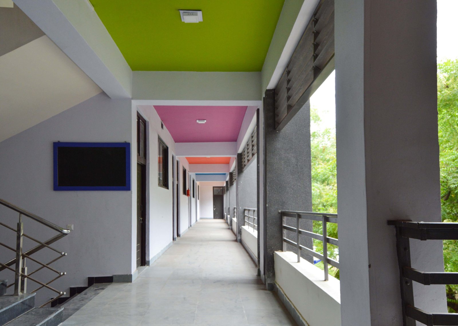 - Exterior of Mehsana Taluka Primary Kumar School showcasing modern sustainable school architecture and dynamic facade in Mehsana, Gujarat - Aerial view of the school campus highlighting green landscape, rainwater harvesting tanks, and shaded walkways - Interior of a flexible classroom with modular furniture, interactive tech stations, and natural light - Collaborative learning zone at Mehsana Taluka Primary Kumar School designed for student creativity and group projects - Solar panels atop the school roof and landscaped courtyard illustrating eco-friendly school design