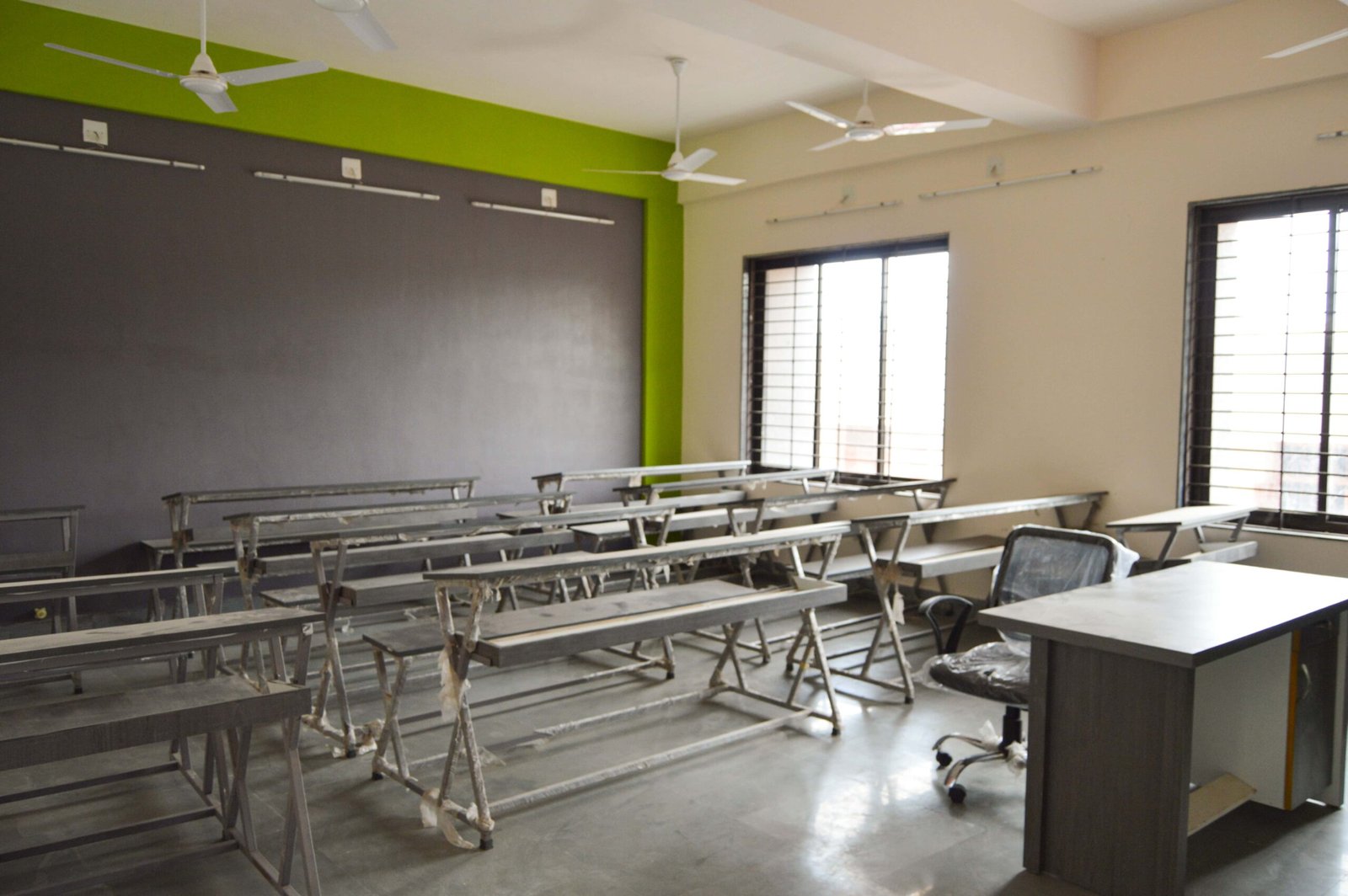- Exterior of Mehsana Taluka Primary Kumar School showcasing modern sustainable school architecture and dynamic facade in Mehsana, Gujarat - Aerial view of the school campus highlighting green landscape, rainwater harvesting tanks, and shaded walkways - Interior of a flexible classroom with modular furniture, interactive tech stations, and natural light - Collaborative learning zone at Mehsana Taluka Primary Kumar School designed for student creativity and group projects - Solar panels atop the school roof and landscaped courtyard illustrating eco-friendly school design