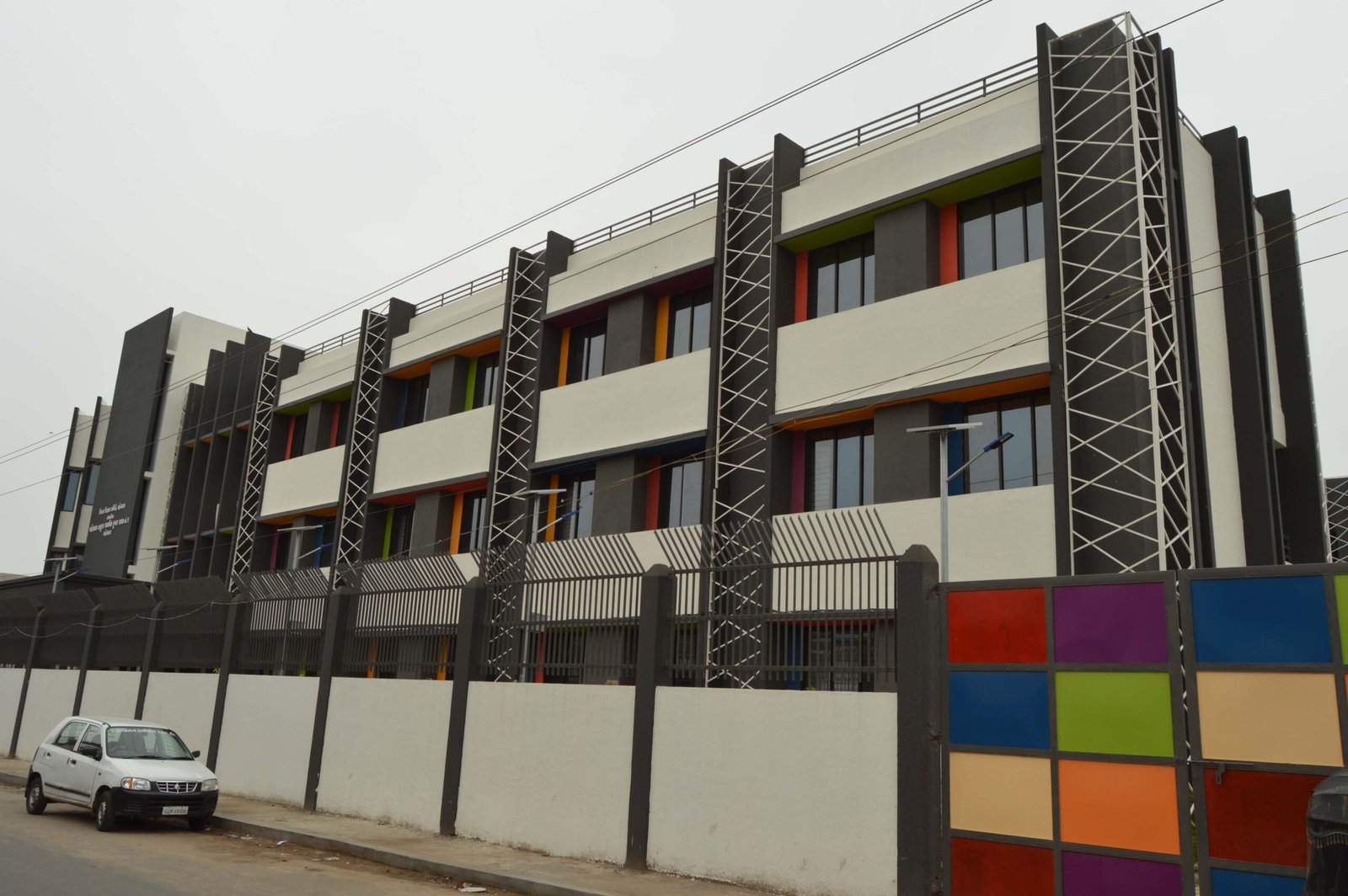 - Exterior of Mehsana Taluka Primary Kumar School showcasing modern sustainable school architecture and dynamic facade in Mehsana, Gujarat - Aerial view of the school campus highlighting green landscape, rainwater harvesting tanks, and shaded walkways - Interior of a flexible classroom with modular furniture, interactive tech stations, and natural light - Collaborative learning zone at Mehsana Taluka Primary Kumar School designed for student creativity and group projects - Solar panels atop the school roof and landscaped courtyard illustrating eco-friendly school design