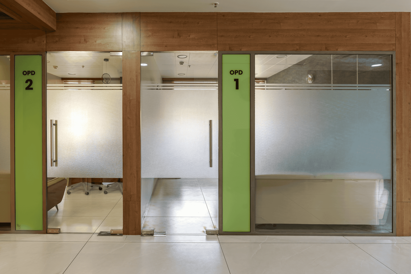 Reception and waiting area of Olwen Hospital in Ahmedabad designed by Vastu Nirman Architects featuring warm wood finishes and calming interior design