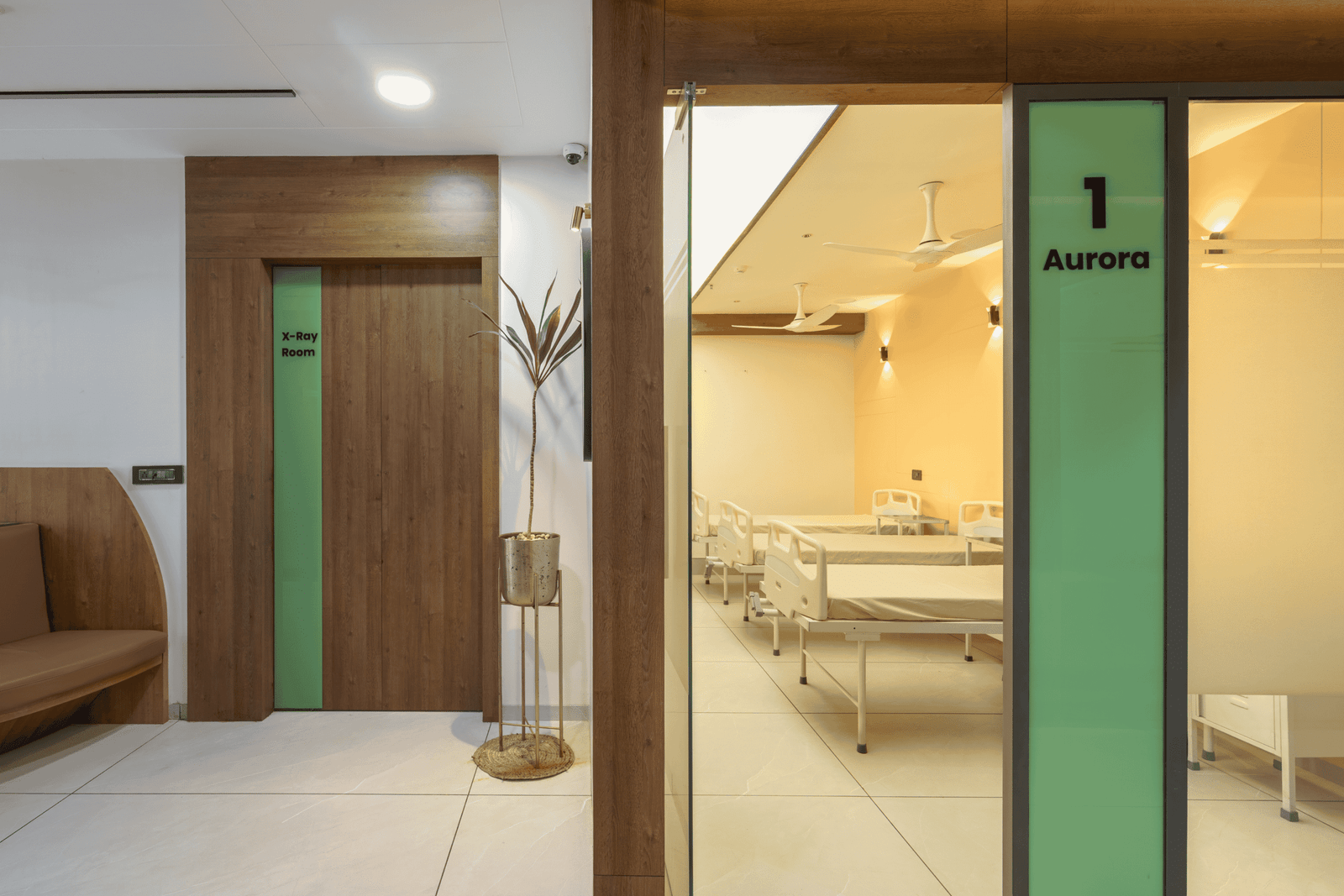 Reception and waiting area of Olwen Hospital in Ahmedabad designed by Vastu Nirman Architects featuring warm wood finishes and calming interior design