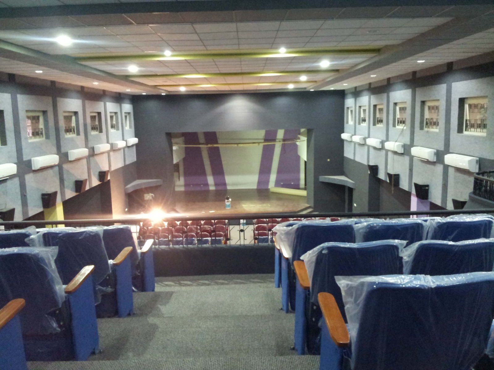 - Front elevation of the restored Sardar Townhall in Rajpipla, showcasing the heritage façade with ornate cornices and columns - Interior view of the refurbished hall with vibrant wall murals, contemporary seating, and updated lighting fixtures - Close-up of decorative plasterwork and restored wooden beams highlighting the building’s historical craftsmanship - Auditorium perspective featuring the renovated stage, modern AV equipment, and flexible seating layout - Nighttime shot of Sardar Townhall illuminated to accentuate architectural details and the entrance canopy