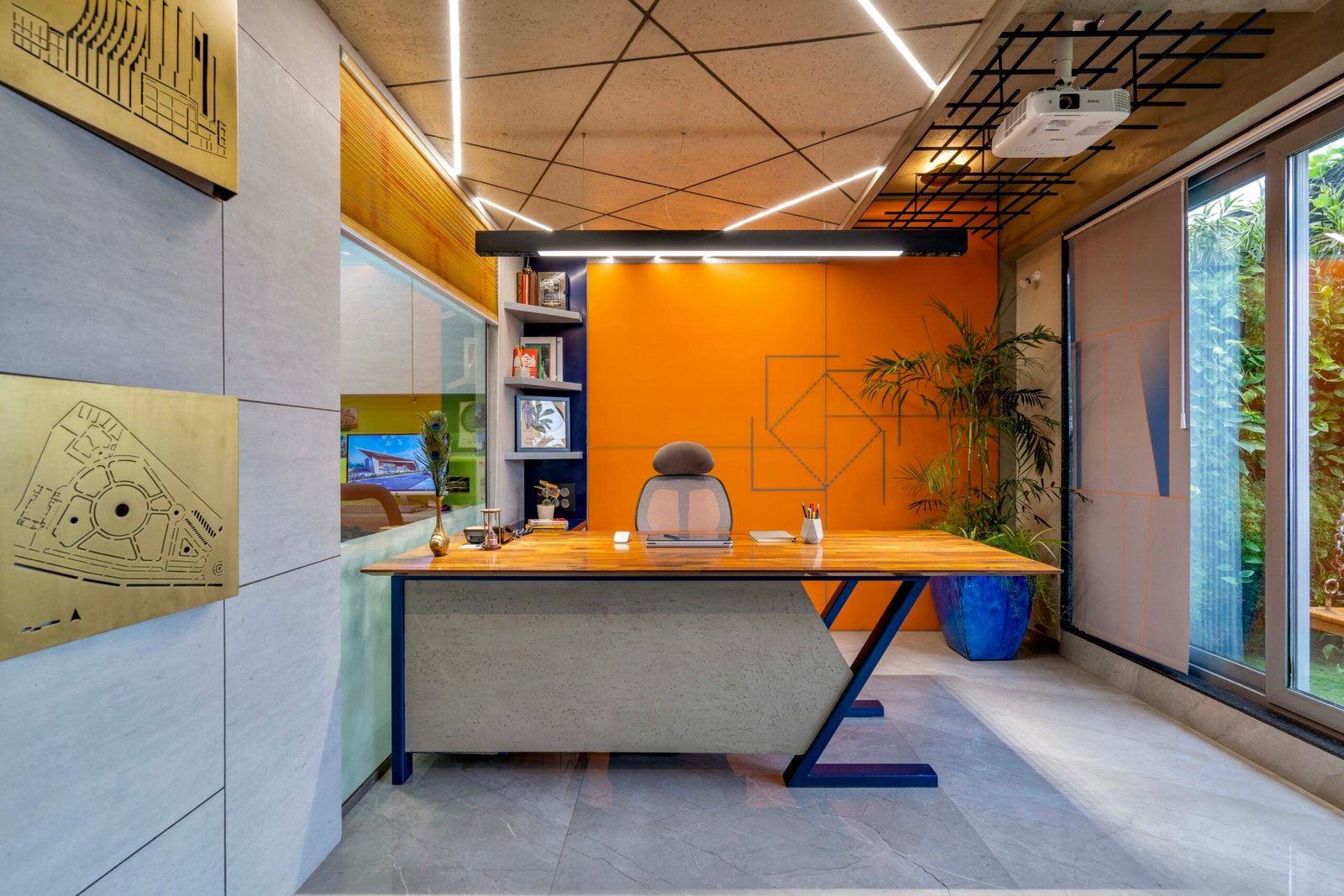 -Exterior shot of Vastu Nirman Architects’ Office in Ahmedabad featuring a minimalist façade, green planter boxes, and entrance signage -Reception area with vibrant accent wall, sleek minimalist desk, and eco-friendly décor elements -Open-plan collaborative workspace showing adjustable desks, colorful partitions, and abundant natural light -Living wall installation and indoor plant clusters creating a green oasis within the office interior -Flexible brainstorming zone with modular seating, writable wall panels, and sustainable lighting fixtures